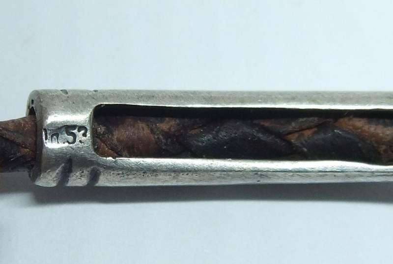 AN UNUSUAL VINTAGE LEATHER BRACELET WITH STERLING SILVER CLASP AND HIGH GRADE SILVER CENTREPIECE