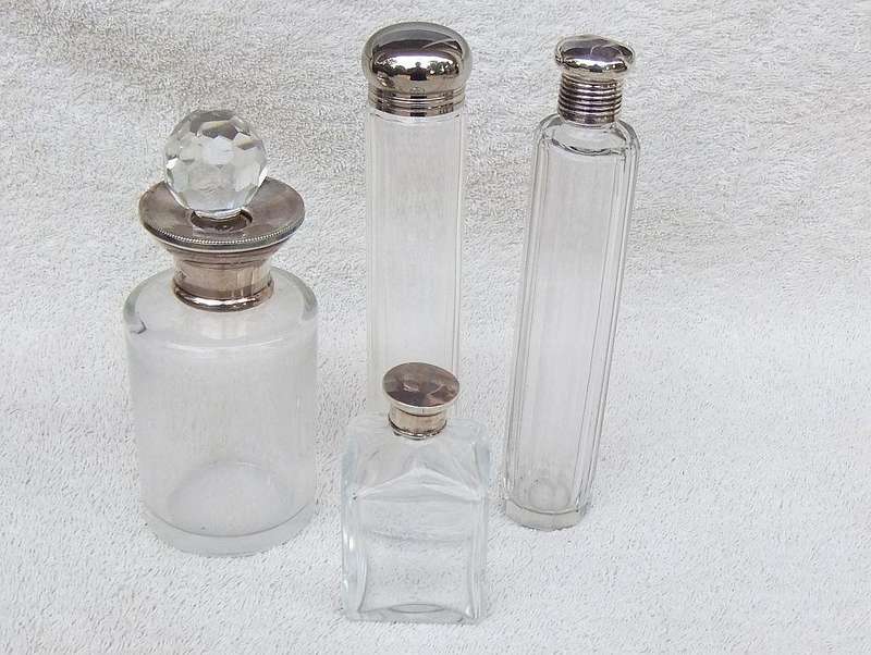AN ANTIQUE BOTTLE WITH HALLMARKED SILVER COLLAR DATED 1918 , ANOTHER WITH SILVER LID PLUS 2 MORE !!