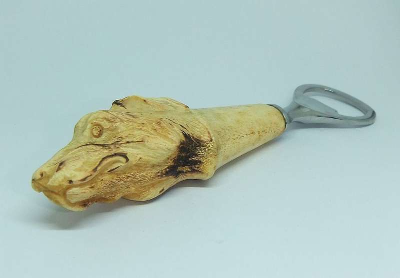 A VINTAGE CARVED BONE DOG MOTIF BOTTLE OPENER BY LEPPINGTON SHEFFIELD ENGLAND