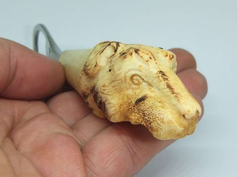 A VINTAGE CARVED BONE DOG MOTIF BOTTLE OPENER BY LEPPINGTON SHEFFIELD ENGLAND