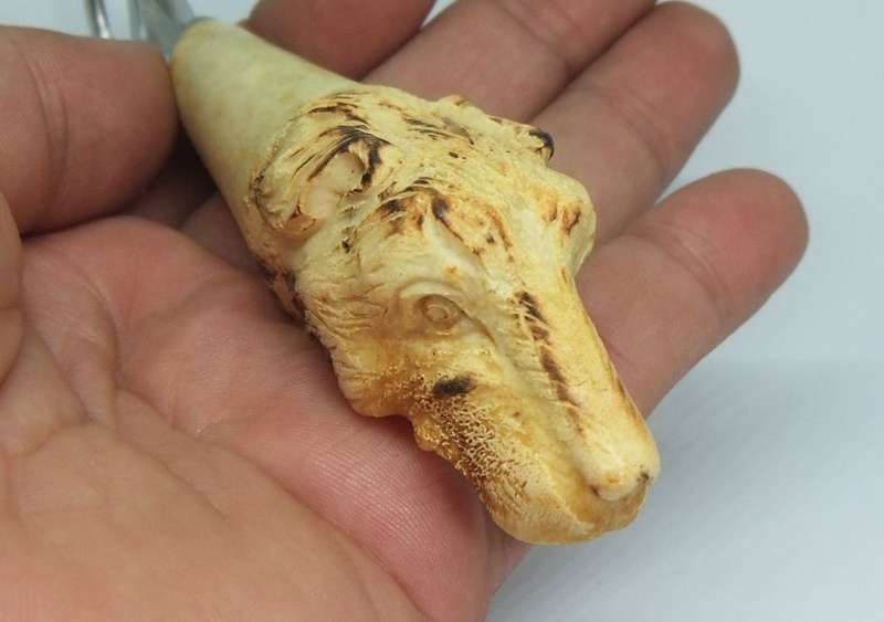 A VINTAGE CARVED BONE DOG MOTIF BOTTLE OPENER BY LEPPINGTON SHEFFIELD ENGLAND