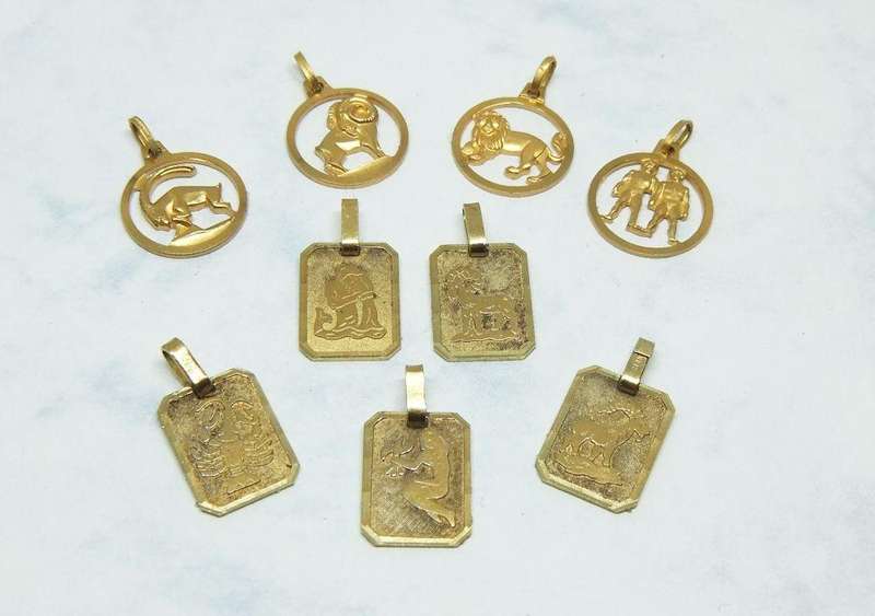 A LOT OF 9 VINTAGE UNUSED GOLD PLATED ZODIAC MOTIF PENDANTS MADE IN GERMANY