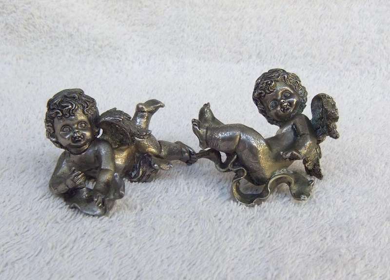 A PAIR OF CHERUB ORNAMENTS DIPPED IN A SILVER METAL FINISH - NO MARKINGS