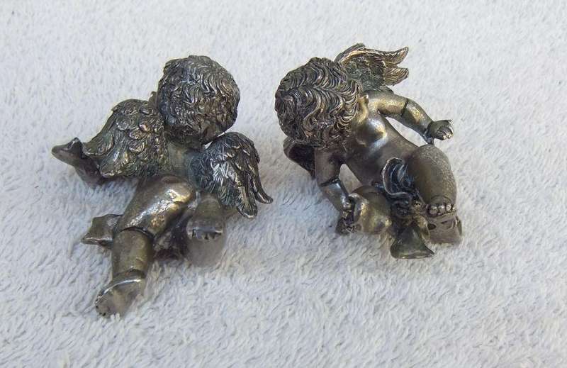 A PAIR OF CHERUB ORNAMENTS DIPPED IN A SILVER METAL FINISH - NO MARKINGS