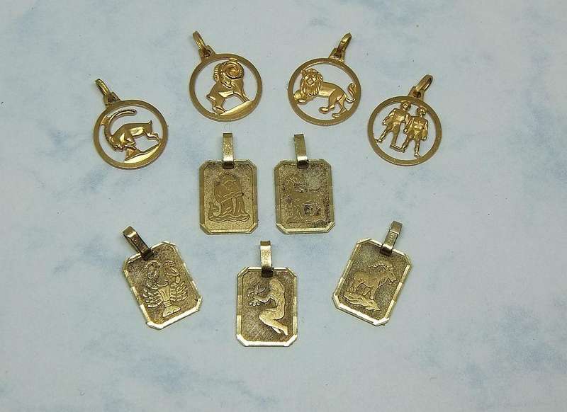 A LOT OF 9 VINTAGE UNUSED GOLD PLATED ZODIAC MOTIF PENDANTS MADE IN GERMANY