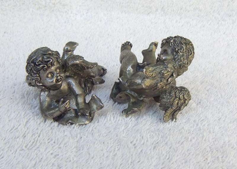 A PAIR OF CHERUB ORNAMENTS DIPPED IN A SILVER METAL FINISH - NO MARKINGS