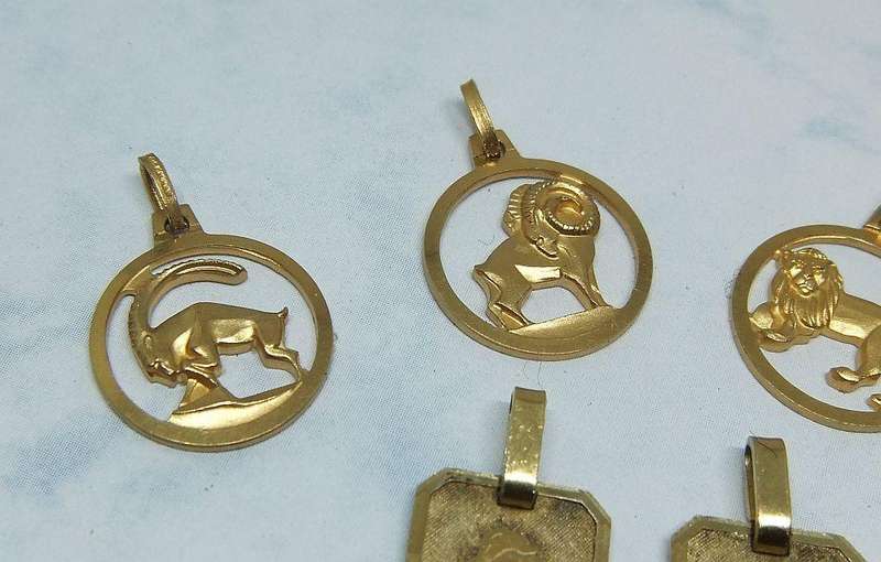 A LOT OF 9 VINTAGE UNUSED GOLD PLATED ZODIAC MOTIF PENDANTS MADE IN GERMANY