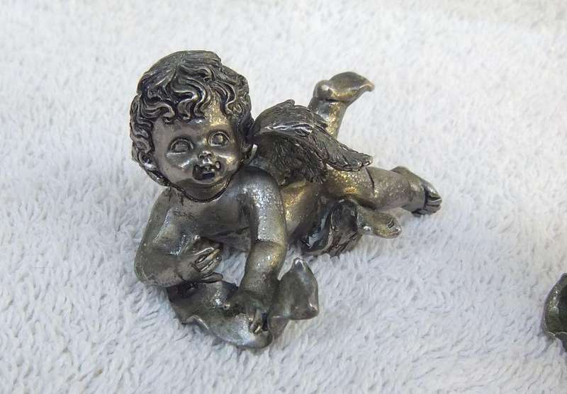 A PAIR OF CHERUB ORNAMENTS DIPPED IN A SILVER METAL FINISH - NO MARKINGS