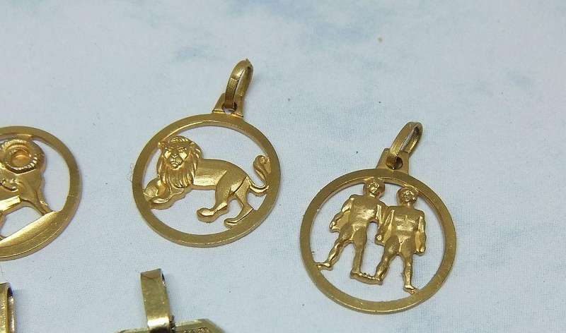 A LOT OF 9 VINTAGE UNUSED GOLD PLATED ZODIAC MOTIF PENDANTS MADE IN GERMANY