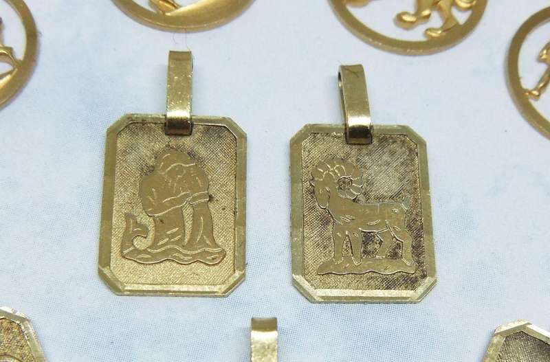 A LOT OF 9 VINTAGE UNUSED GOLD PLATED ZODIAC MOTIF PENDANTS MADE IN GERMANY