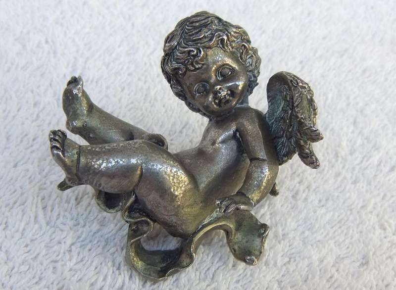 A PAIR OF CHERUB ORNAMENTS DIPPED IN A SILVER METAL FINISH - NO MARKINGS