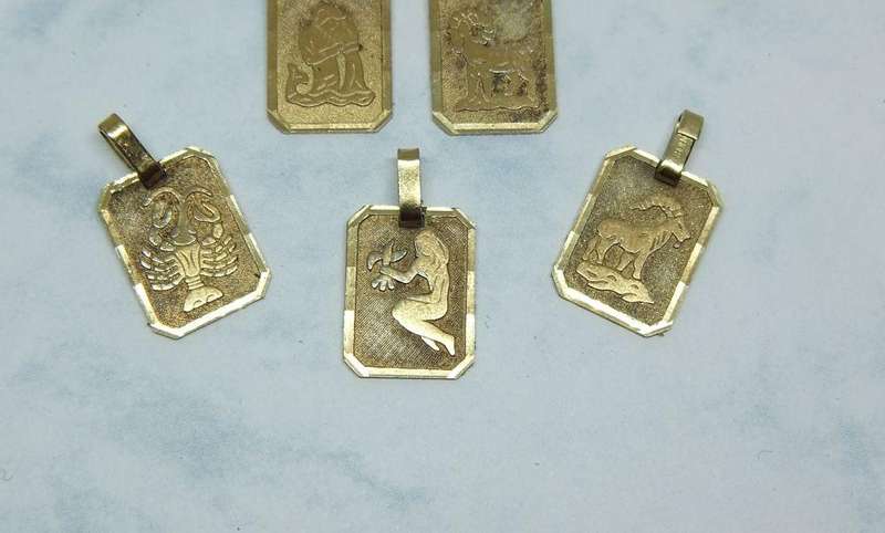 A LOT OF 9 VINTAGE UNUSED GOLD PLATED ZODIAC MOTIF PENDANTS MADE IN GERMANY
