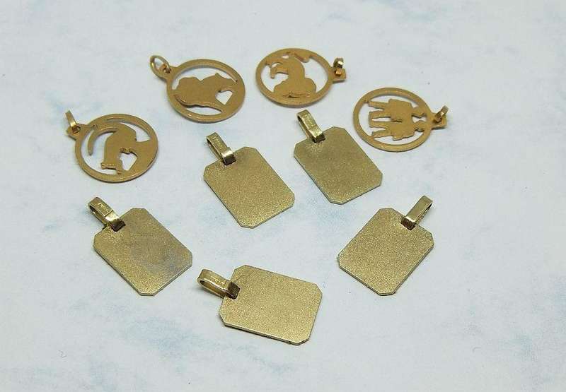 A LOT OF 9 VINTAGE UNUSED GOLD PLATED ZODIAC MOTIF PENDANTS MADE IN GERMANY