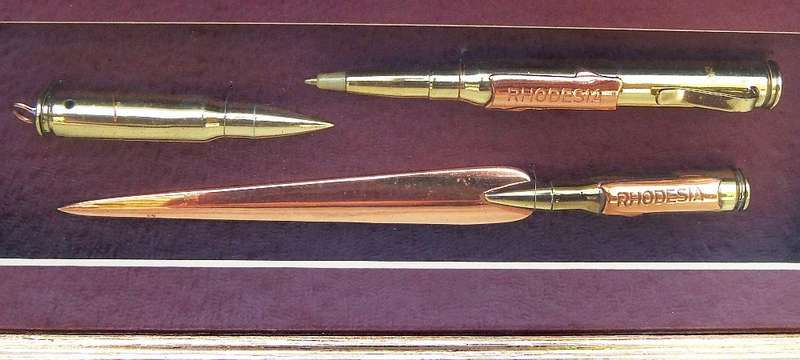 RARE FIND !! A VINTAGE BOX FRAME CONTAINING THREE PIECES OF RHODESIAN BUSH WAR TRENCH ART !! WOW !!
