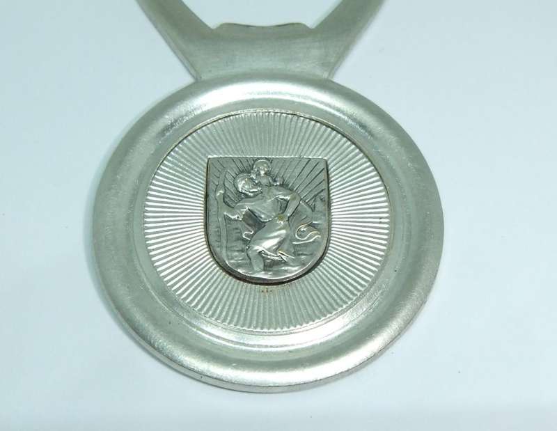 A VINTAGE SILVERPLATE BOTTLE OPENER DEPICTING ST. CHRISTOPHER