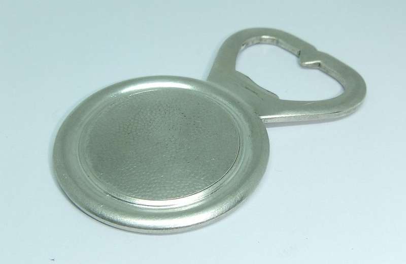 A VINTAGE SILVERPLATE BOTTLE OPENER DEPICTING ST. CHRISTOPHER