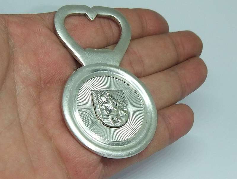 A VINTAGE SILVERPLATE BOTTLE OPENER DEPICTING ST. CHRISTOPHER