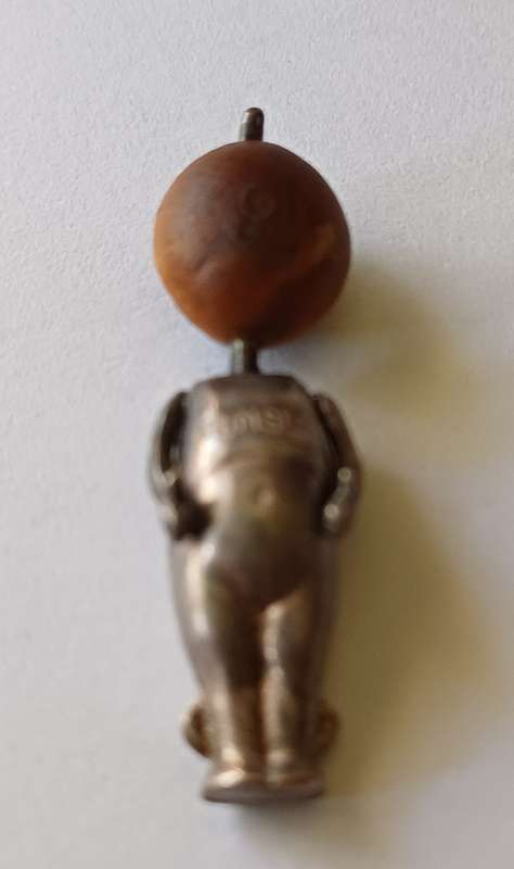 A WWI Fumsup lucky charm | Silver | has articulated arms |