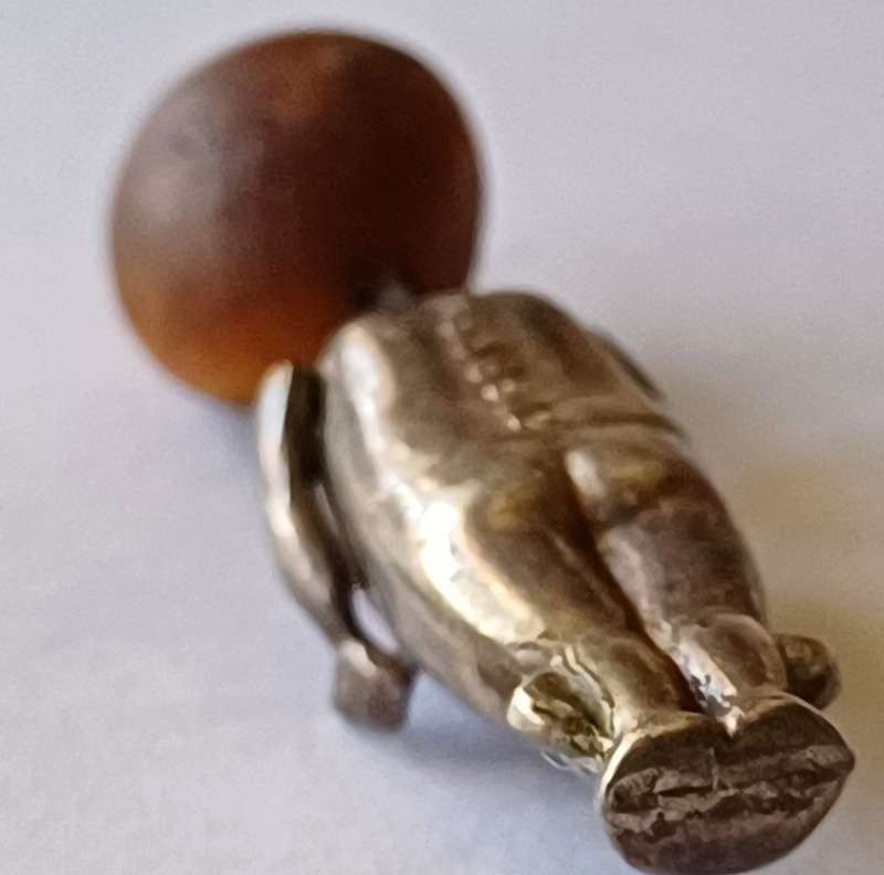 A WWI Fumsup lucky charm | Silver | has articulated arms |