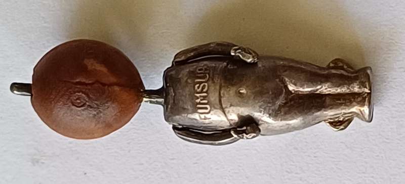 A WWI Fumsup lucky charm | Silver | has articulated arms |