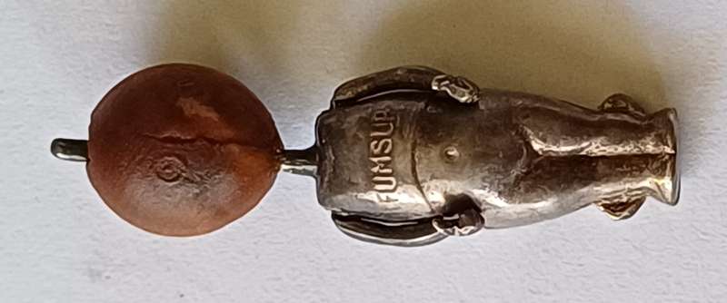 A WWI Fumsup lucky charm | Silver | has articulated arms |