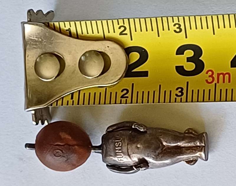 A WWI Fumsup lucky charm | Silver | has articulated arms |