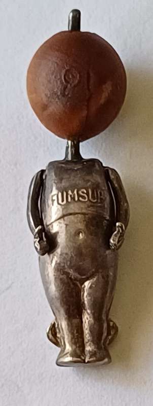 A WWI Fumsup lucky charm | Silver | has articulated arms |