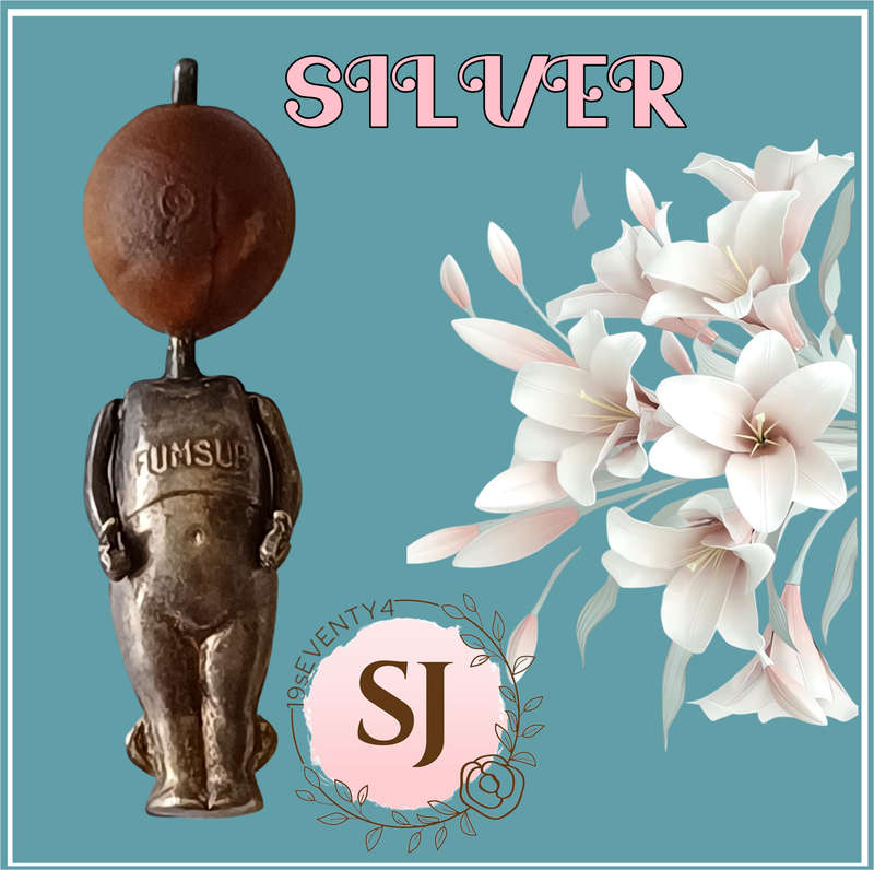 A WWI Fumsup lucky charm | Silver | has articulated arms |