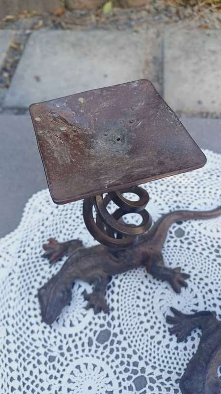 Pair of twisted metal candle stands with lizard bases