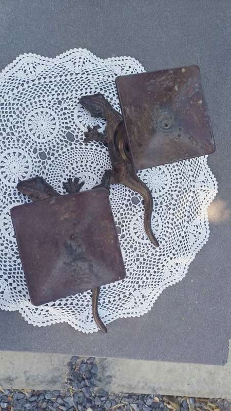 Pair of twisted metal candle stands with lizard bases