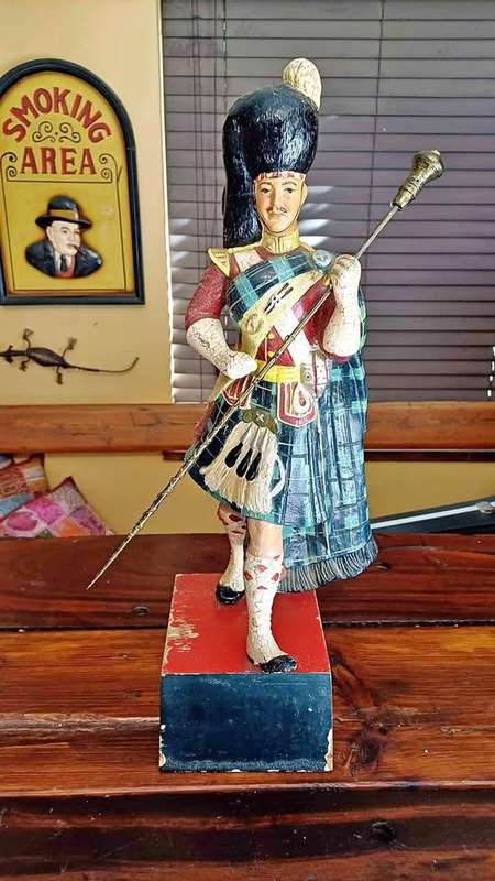 Large 1950s Dewar's White Label scotch whisky advertising statue in traditional Highland attire