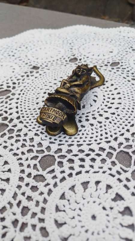 Vintage brass door knocker. Cheeky Dartmoor Pixie sitting on a toadstool