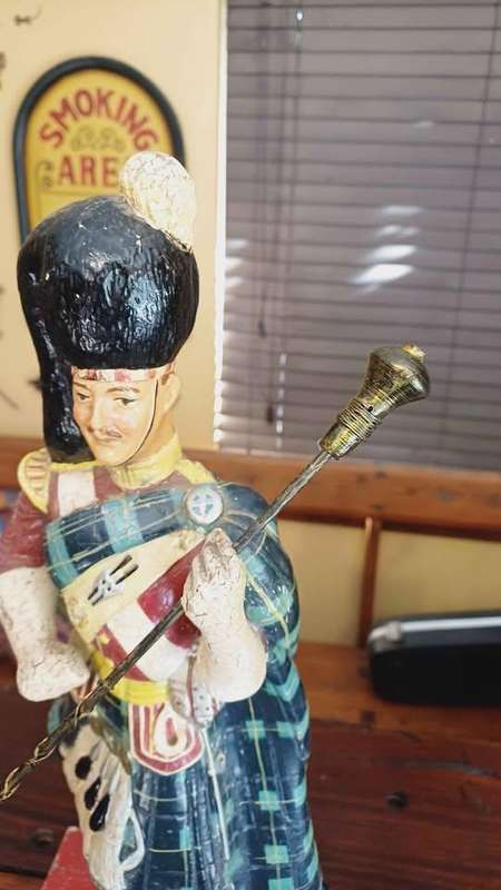 Large 1950s Dewar's White Label scotch whisky advertising statue in traditional Highland attire