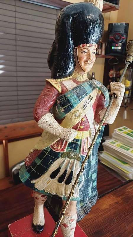 Large 1950s Dewar's White Label scotch whisky advertising statue in traditional Highland attire