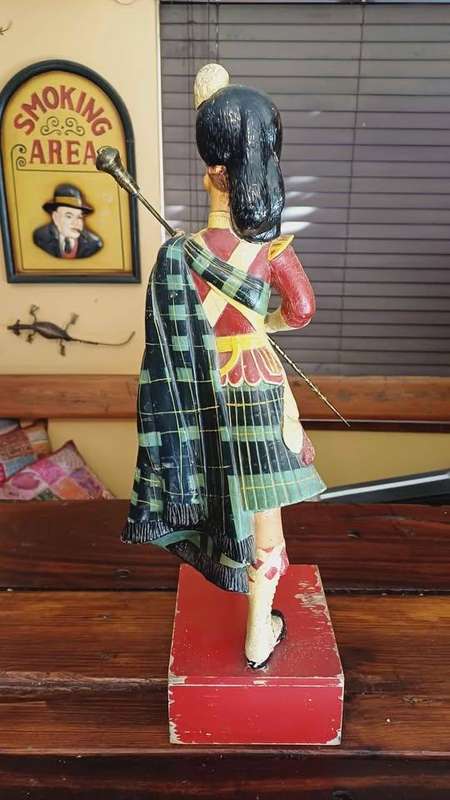 Large 1950s Dewar's White Label scotch whisky advertising statue in traditional Highland attire