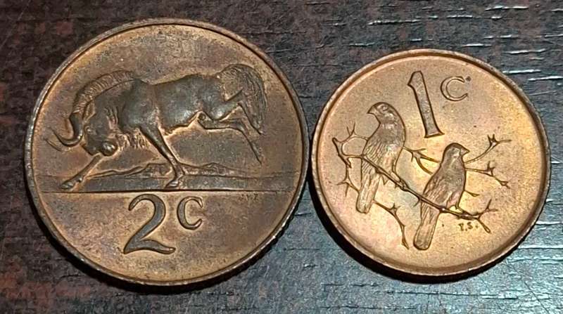 1966 2-cent coin and a 1-cent coin