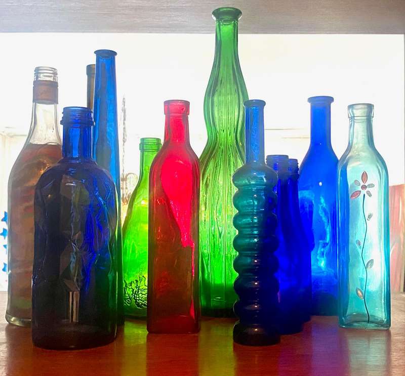 10 different sizes, coloured glassware bottles as displayed