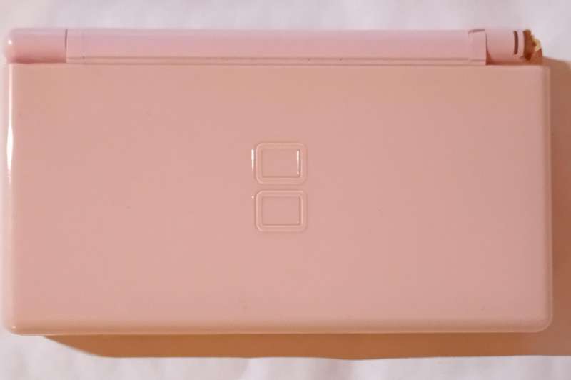 Nintendo DS Lite console with 4 games and pouch