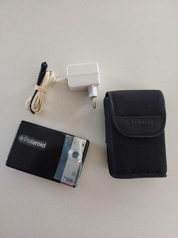 Poloroid Pogo instant digital camera (LIKE NEW) still has plastics on the camera.