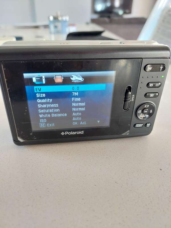Poloroid Pogo instant digital camera (LIKE NEW) still has plastics on the camera.