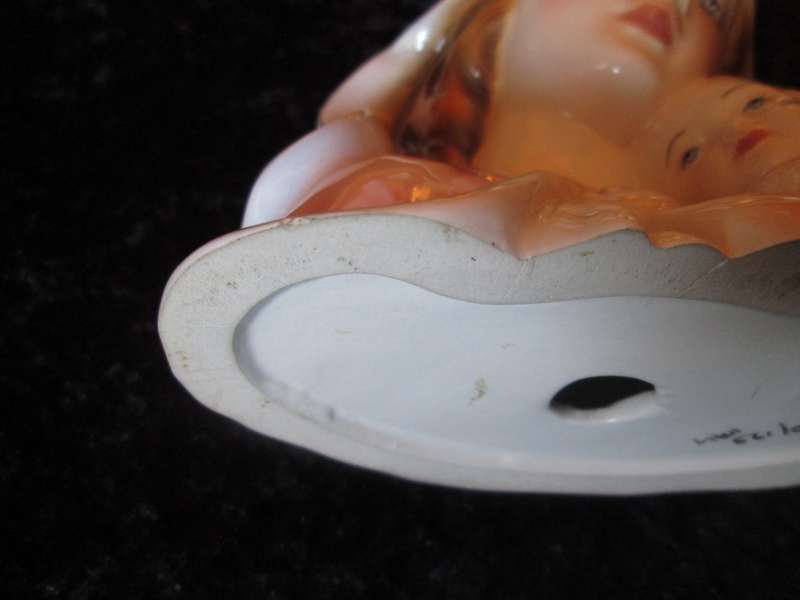 Italian Madonna and Child. 2 very small flea bites and a manufacturing defect as indicated.