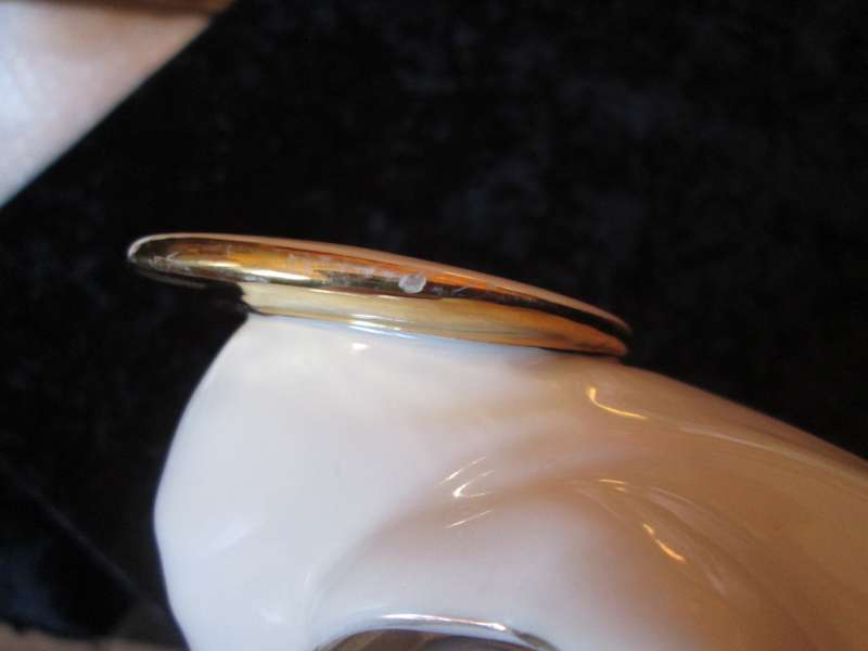 Italian Madonna and Child. 2 very small flea bites and a manufacturing defect as indicated.