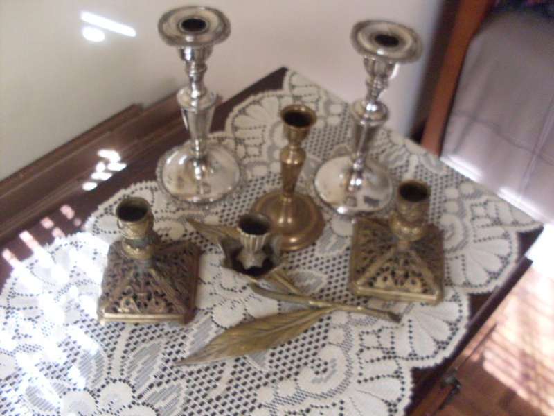 A COLLECTION OF CANDLE HOLDERS....SILVER PLATED AND BRASS
