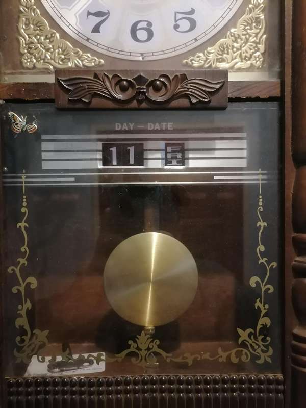 A vintage Blessing 31 day clock w/ day & date in a wood wall casing. Lifespace Sale - With Key