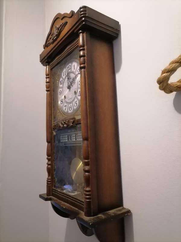A vintage Blessing 31 day clock w/ day & date in a wood wall casing. Lifespace Sale - With Key