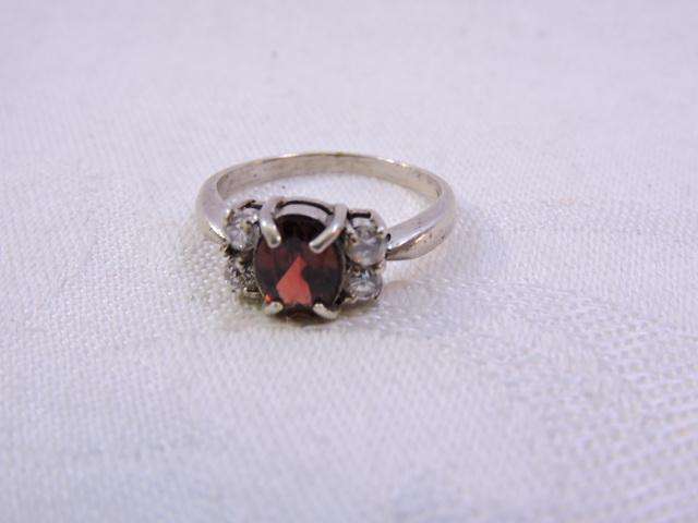 Sterling Silver Ring with Garnet & 2 x fair sized Zirconia's on either side  ( Red stone )