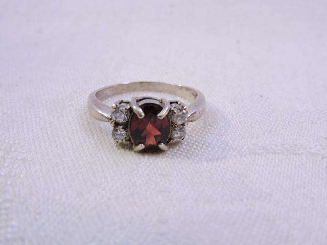 Sterling Silver Ring with Garnet & 2 x fair sized Zirconia's on either side  ( Red stone )