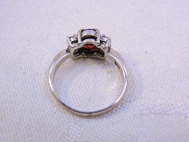 Sterling Silver Ring with Garnet & 2 x fair sized Zirconia's on either side  ( Red stone )
