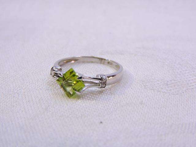 Sterling Silver Ring with Peridot & 3 x small Zirconia's on either side  ( light green stone )