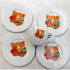 MINIATURE CHINA TEDDY BEAR CUP WITH FOUR PLATES